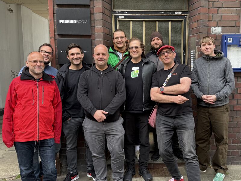 9 attendees of IndieWebCamp standing outside the venue which is a former pub