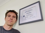 Calum beside his IAAP WAS certificate