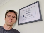 Calum beside his IAAP WAS certificate