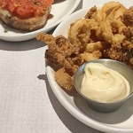 Selection of tapas dishes including calamari and dip