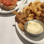 Selection of tapas dishes including calamari and dip