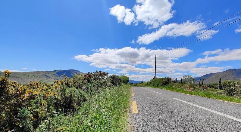 Country road in Ireland with backdrop of hills