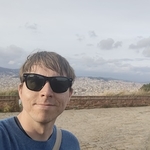 Calum wearing sunglasses with backdrop of Barcelona skyline