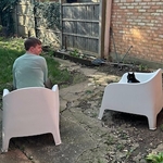 Calum and Bagheera sitting in white garden chairs