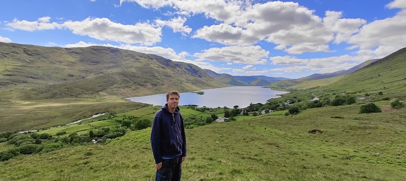 Calum with backdrop of lake and mountains