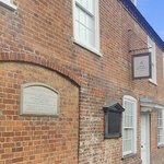Frontage brick wall with sign of Jane Austen's house