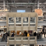 Interior of V&A East with cut-out concrete glazed wall of council housing hung on side of walkways