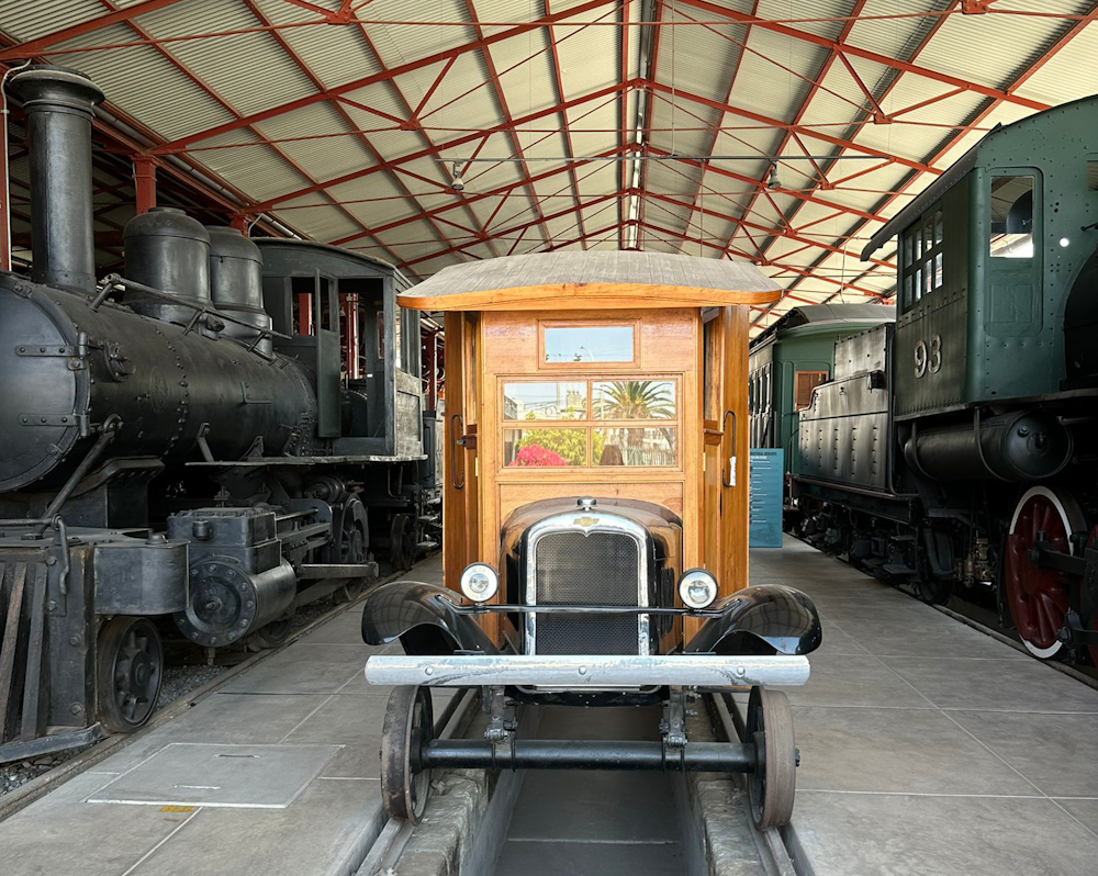 A vintage car mounted on rails