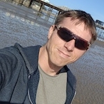 Calum beside Hastings Pier