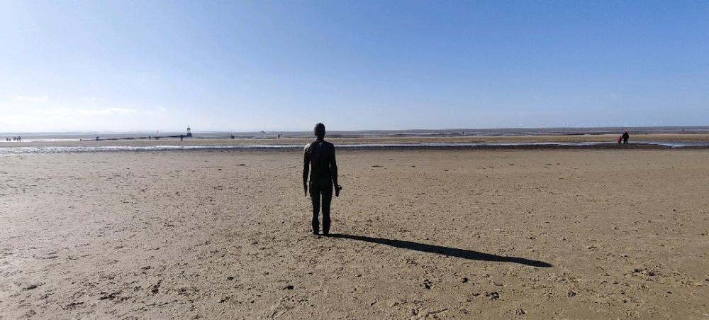 sculpture of human on beach