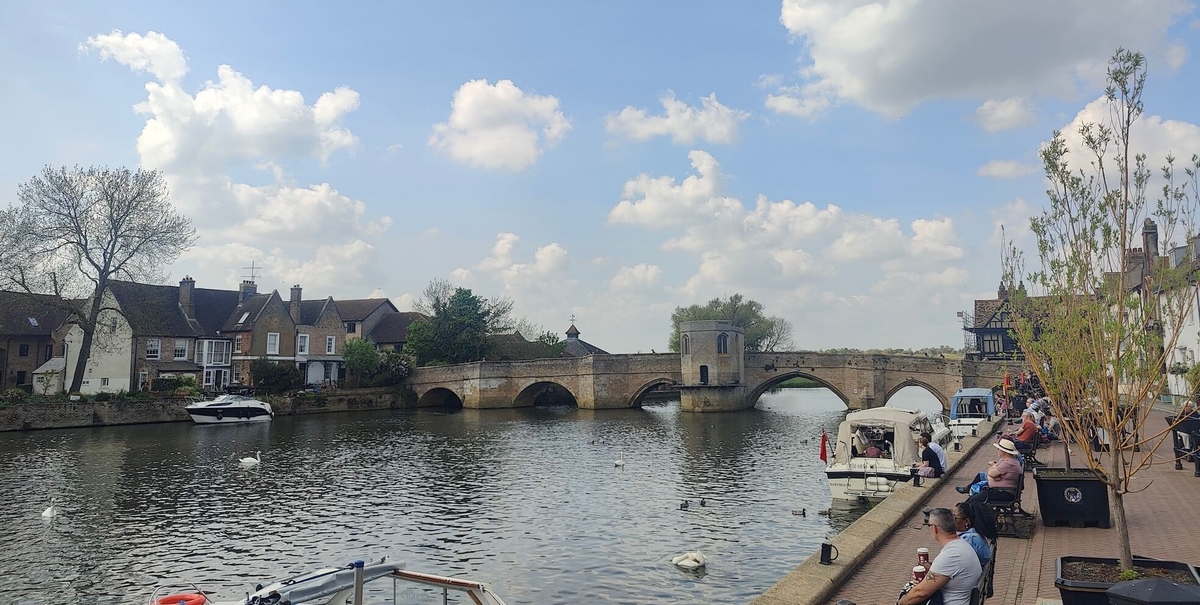 Sunny day in St Ives, Cambridgeshire, by the River Great Ouse, with a historic stone bridge.
