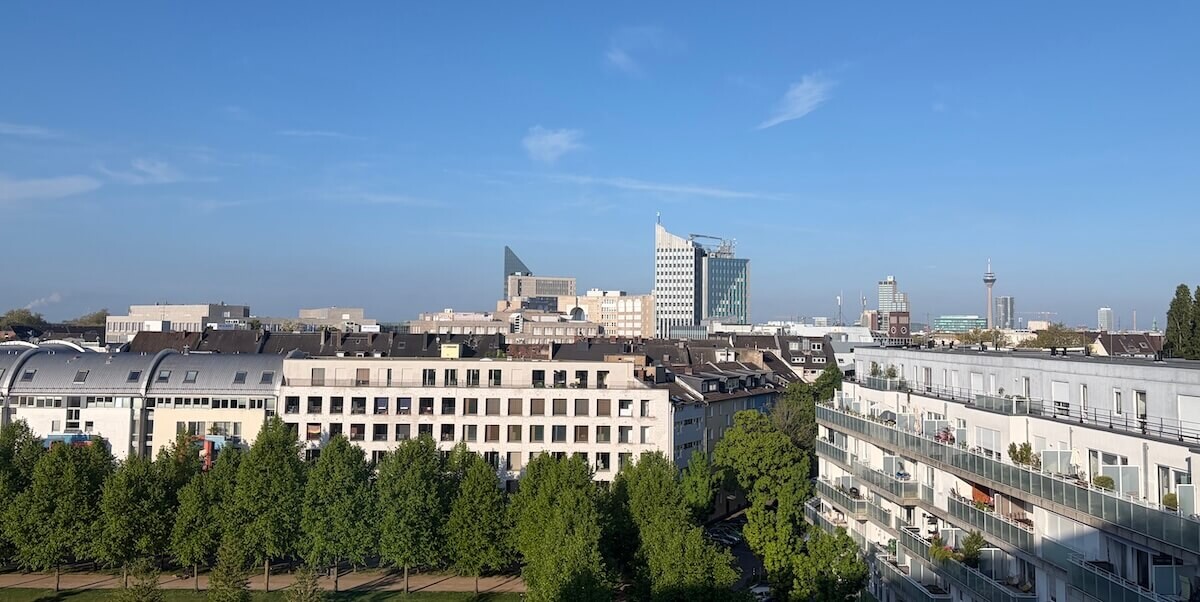 Dusseldorf skyline on a clear morning with mostly white coloured apartments and towers