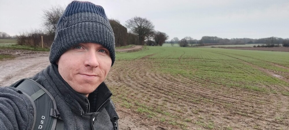Calum standing in muddy field near Tonbridge