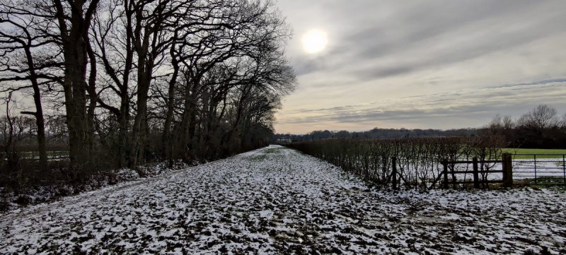 Bridle path near Tonbridge with melting snow and sun peaking through clouds