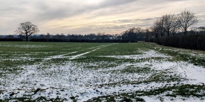 Partly snowy field near Tonbridge on a winter afternoon