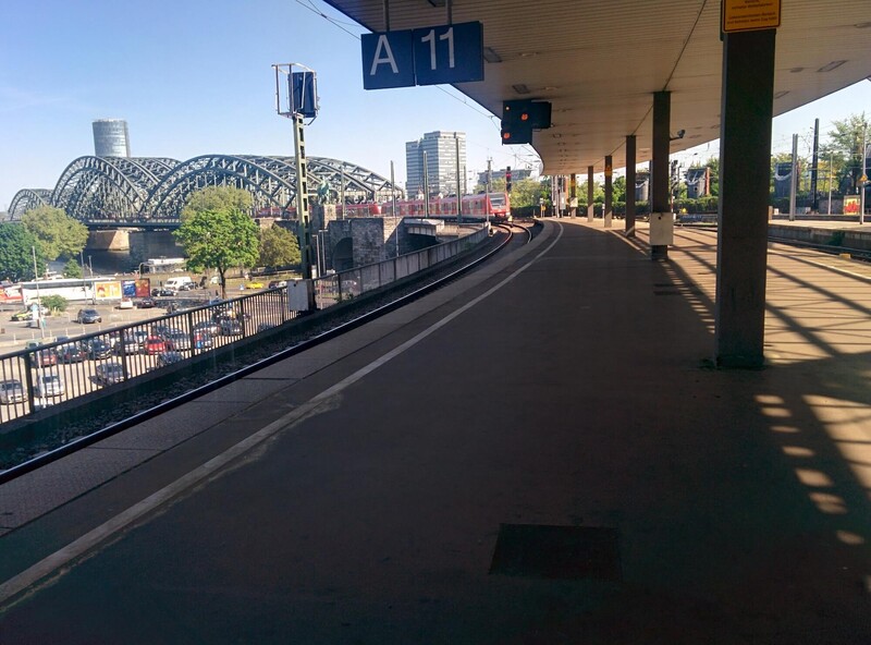 Cologne station view of bridge and RE train arriving