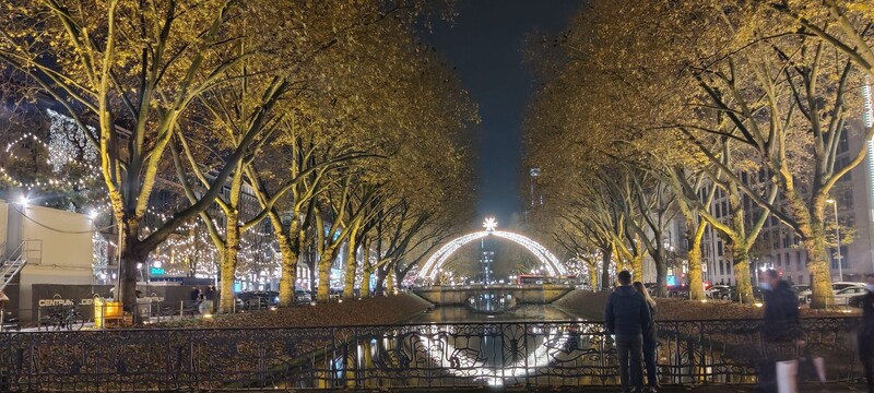 Night shot of Düsseldorf river and Christmas arc of lights with star