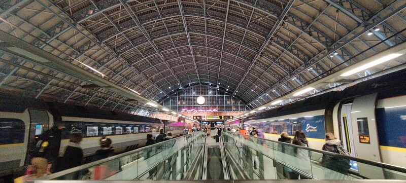 Night time London St Pancras terminal shot with two trains and station clock