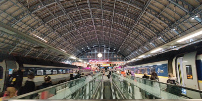 Night time London St Pancras terminal shot with two trains and station clock