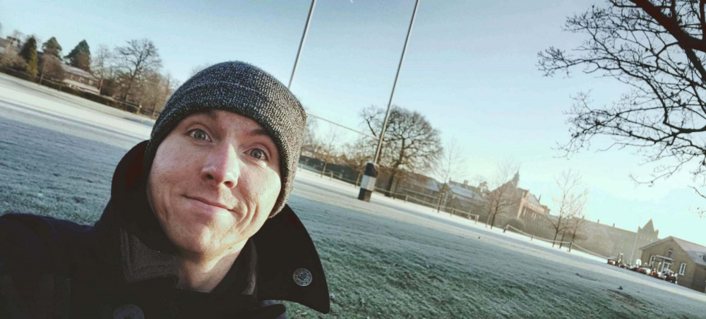 Calum headshot with backdrop of Tonbridge School rugby pitch on frosty day