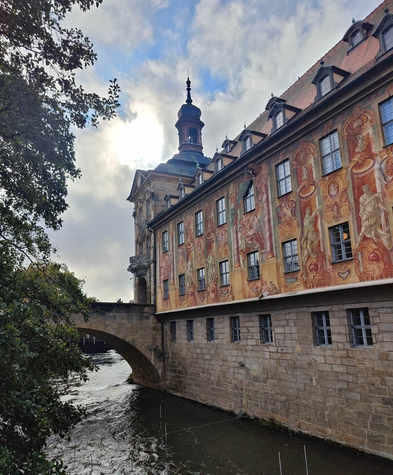 River view with bridge, clock tower and painted building beside