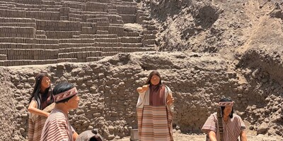 Huaca Pucllana pyramid with a group of lifesize figures from the period re-enacting making food