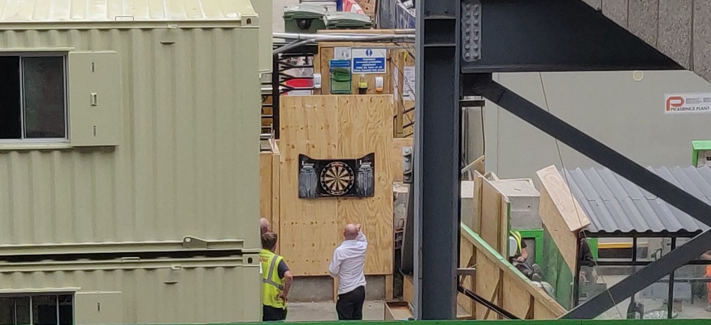 Crossrail construction site at Moorgate with men playing darts