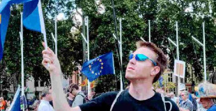Standing on Parliament Square holding an EU flag